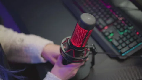 Lady Adjusting Mic and Keyboard Under Hue Lighting in Cozy Tech Setup Stock Footage 307458743