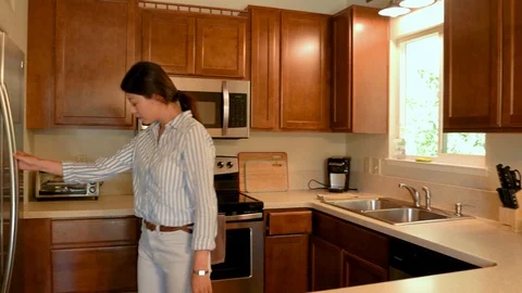 Lady after work putting grocery in fridge Video stock 109602786