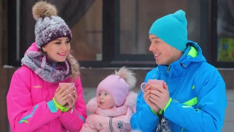 Lady and man pose for camera holding tea cups and daughter 库存影片 134236052