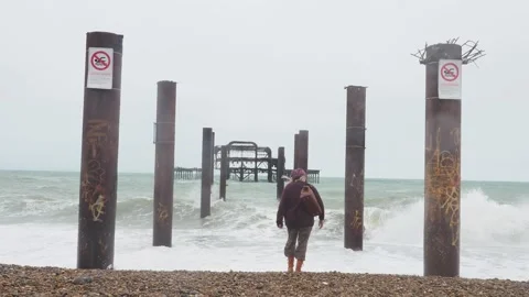 Lady Approaches An Empty Pier On The Coast Of The UK, In July, Stock Footage 134714154