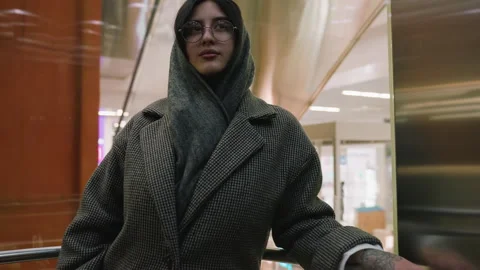 Lady Ascending Elevator with City Mall View in Background Vídeos de archivo 310147782