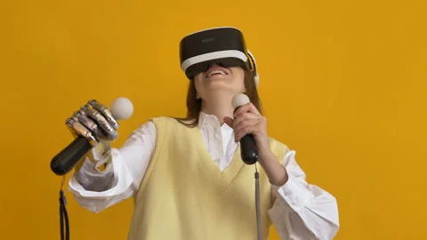 Lady with bionic arm uses virtual reality headset on yellow Stock Footage 150240743