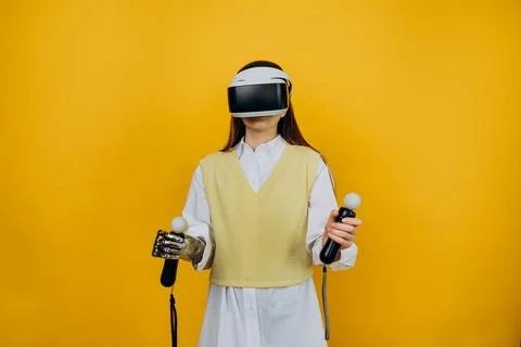 Lady with bionic arm virtual reality goggles and joysticks Stock Photos