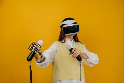 Lady with bionic arm virtual reality goggles and joysticks Stock Photos