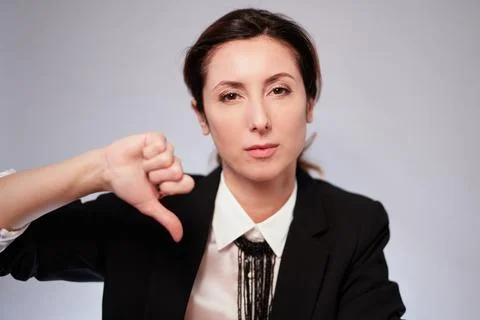 Lady in black jacket making negative gesture looking at camera 库存照片