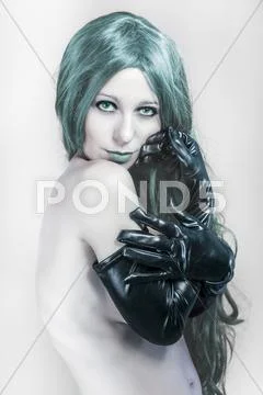 Lady in blue wearing large black gloves, nude woman Stock Photos