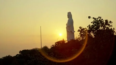 Lady Buddha Statue Sunset with Orange Glowing Halo Video stock 343410756
