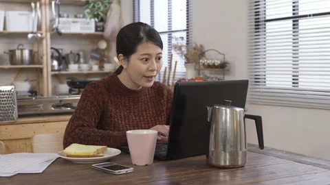 Lady in casual wear is using computer Stock Footage 133694599