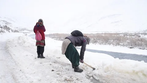 Lady clearing Snow Video stock 128671966