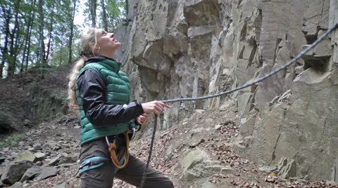 Lady climber secure a partner during climbing Stock Footage 56443432