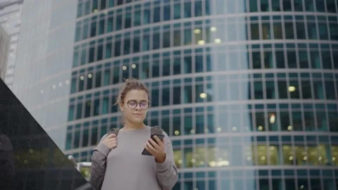 Lady comes out from work and uses phone going down stairs Stock Footage 164838759