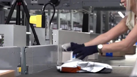 Lady correcting parcels on conveyor - time lapse Stock Footage 83627937