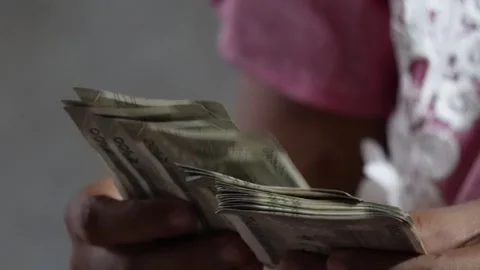 A lady is counting currency notes one by one Stock Footage 314607283