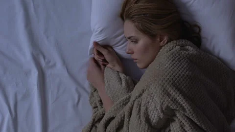 Lady crying touching opposite empty side of bed, missing husband, loneliness Stock Footage 106544572