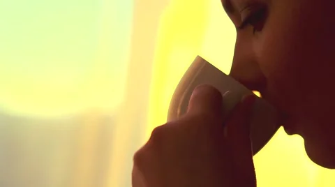 Lady with cup of steaming beverage over beautiful sunlight Stock Footage 50055716