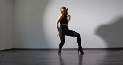 Lady dances in open clothes and high heels. Stock Footage 280480090