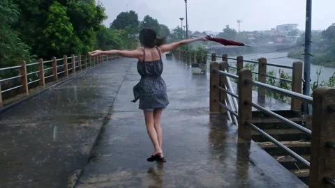 A lady is dancing in the rain. Stock Footage 205550432