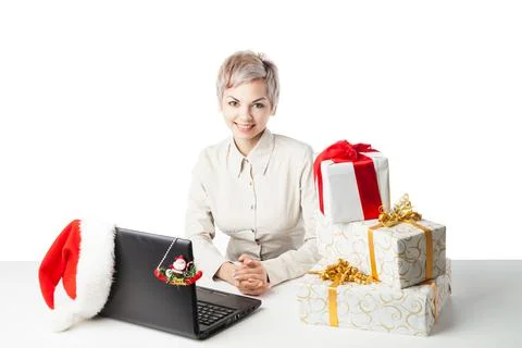 Lady at desk with present boxes and hat over white Stock Photos