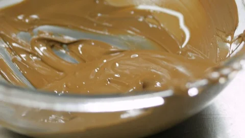 Lady dips cookie into melted milk chocolate and sets on tray 스톡 동영상 93375381