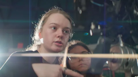 Lady director instructs extra actress on nuances of entrance timing Stock-Footage 303278113
