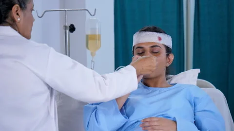 A lady doctor checking body temperature of a female patient with a thermomete... Video stock 212047602