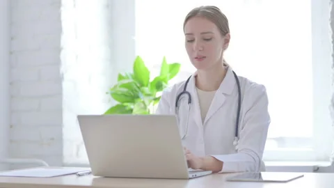 Lady Doctor Smiling at Camera While sitting in Clinic Stock-Footage 204999625