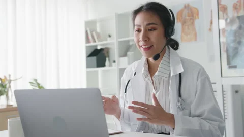 Lady doctor using computer laptop talking video conference call with patient. Stock Footage 148051985