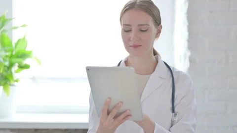 Lady Doctor using Tablet for Work Stock Footage 205000221