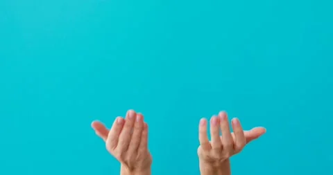 Lady does inviting gestures by elegant hands on turquoise 動画素材 150623162