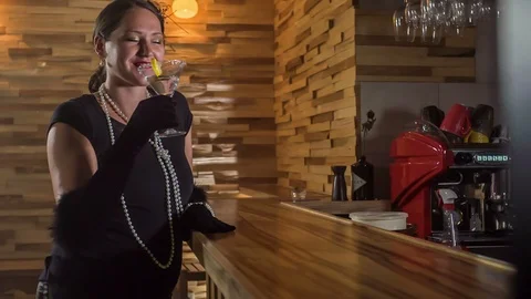 Lady dressed in black is drinking a cocktail Video stock 112192359