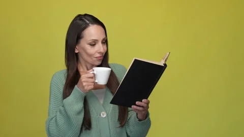 Lady drink espresso read interesting book isolated vivid color background Stock Footage 167361003