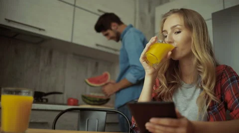Lady drinking jus, man cutting watermelon Stock Footage 68729113