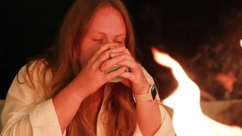 Lady drinking tea near fireplace. Stock Footage 273789810