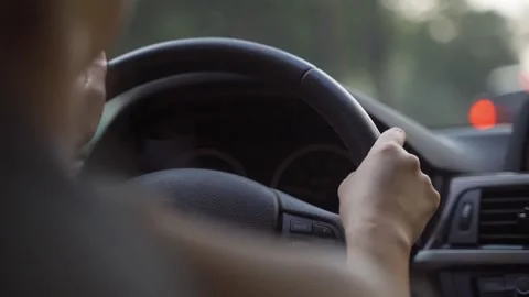 A lady is driving, steering wheel on the left. Stock Footage 163451782