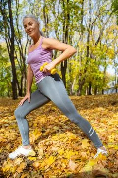 Lady with dumbbells looking at the camera Foto stock
