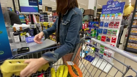 A lady at the empty cash register of a large supermarket without a waiting 動画素材 200111589