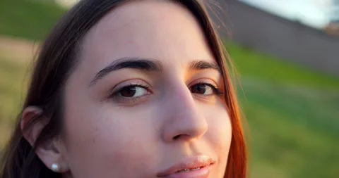 Lady engaging with camera pleasantly. Young woman giving flirty glances to Vídeos de archivo 344718570
