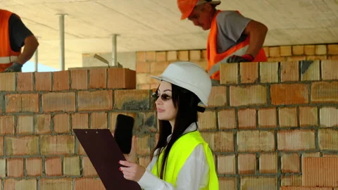 Lady engineer studies document holding clipboard in hand Video stock 317613544