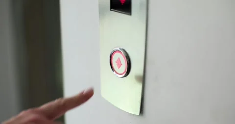 Lady finger presses button to call modern elevator in hallway Stock Footage 261959745