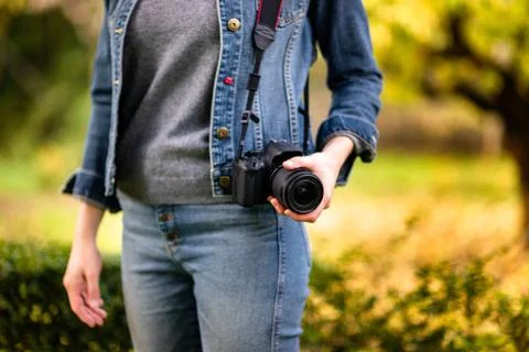 Lady in the garden with a camera 스톡 사진
