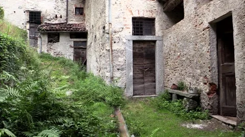A lady gently feeds her hens in a old Italian country house Stock Footage 45045172