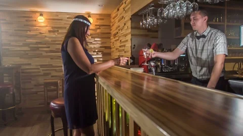 Lady gets another drink at a counter bar Stock Footage 112192436