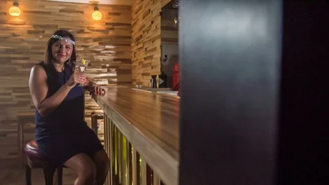 Lady gets a cocktail and then she leaves a counter bar Stock Footage 112192547