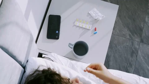 Lady getting sick in bed and take pills Stock Footage 168665643