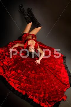 Lady in gypsy costume dancing flamenco on a gray background Stock Photos