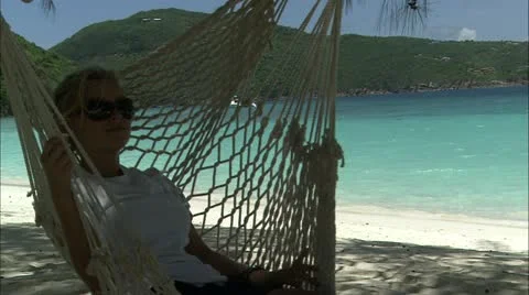 Lady in hammock on beach Stock Footage 22664181