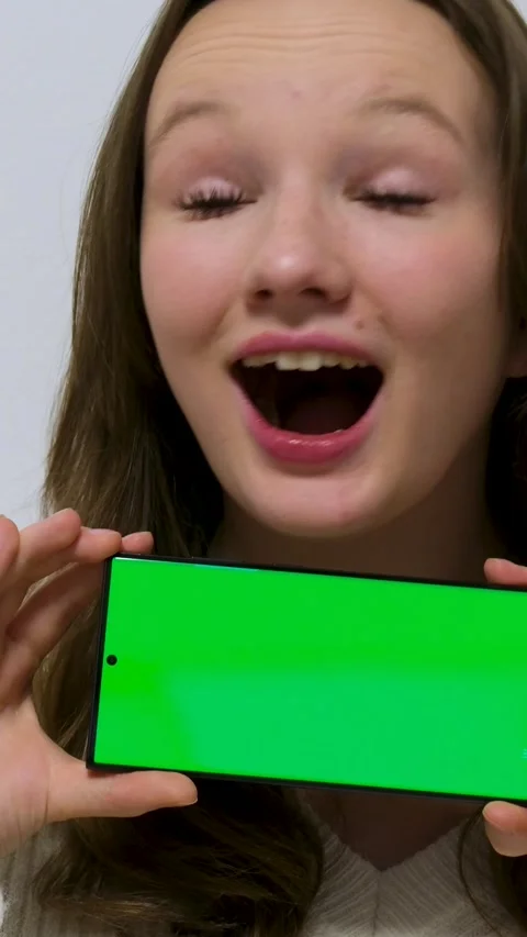 Lady hand tapping chroma key smartphone in company office closeup. woman turning Stock Footage 310789324