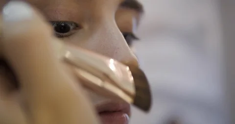 Lady hands apply coloured concealer on young woman nose Stock Footage 124256789
