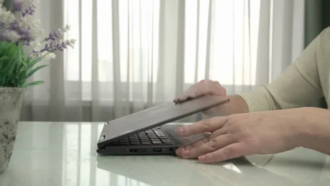 Lady hands open notebook and types sitting at white table Stock Footage 125809544