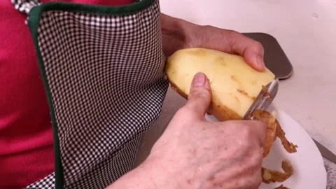Lady hands peeling potatoes Stock Footage 130355071